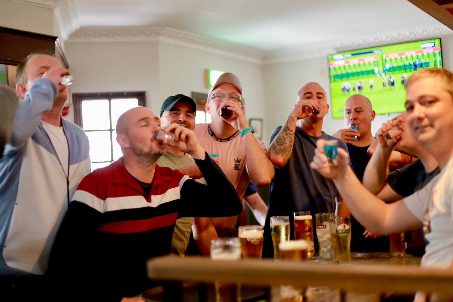 A group of lads doing shots on a race day