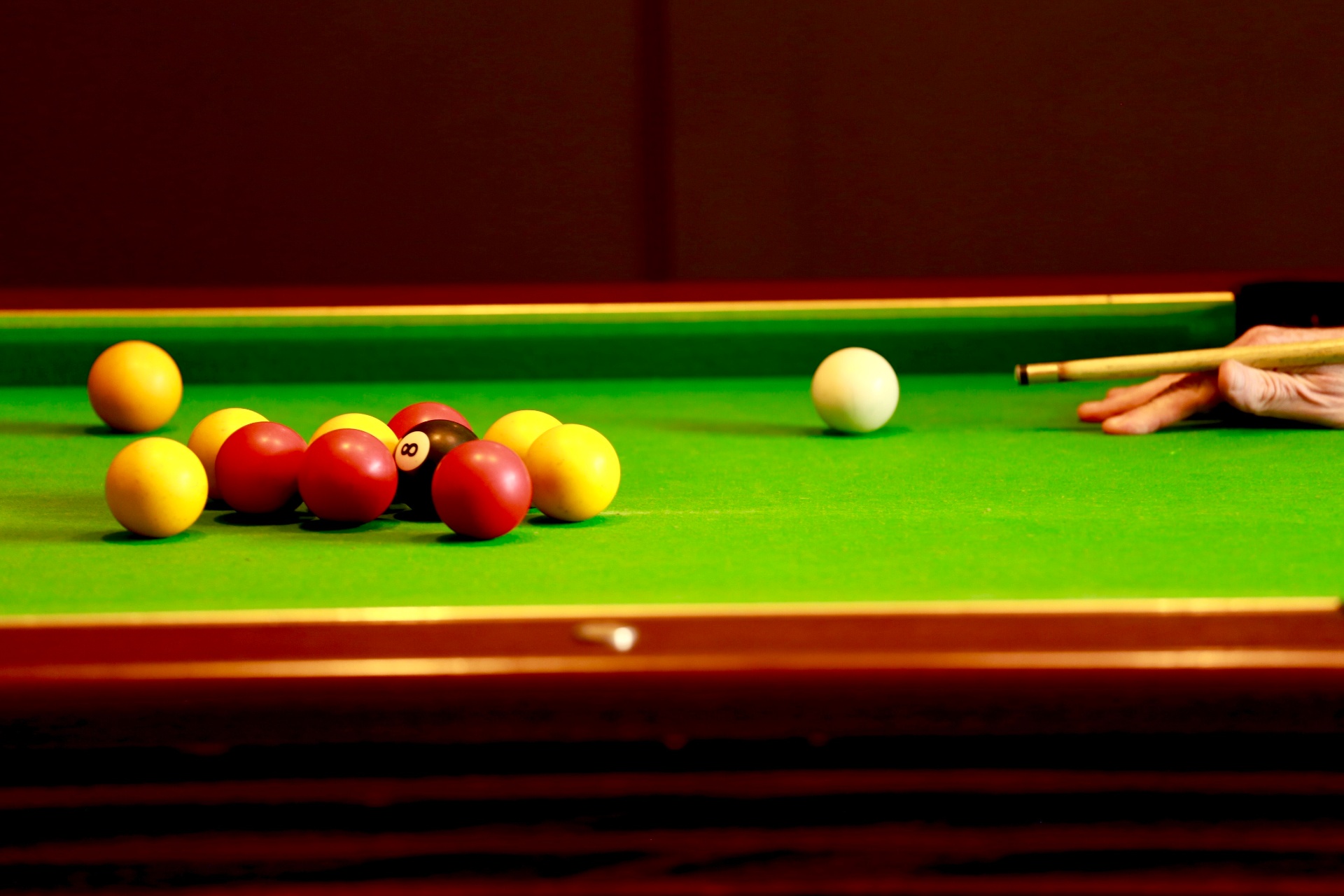 Pool table mid-game with reds, yellows and the eight ball