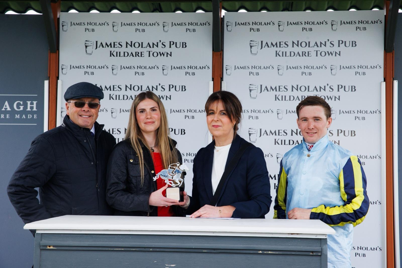 Winners receiving a trophy at James Nolan's Pub sponsored race at the Curragh